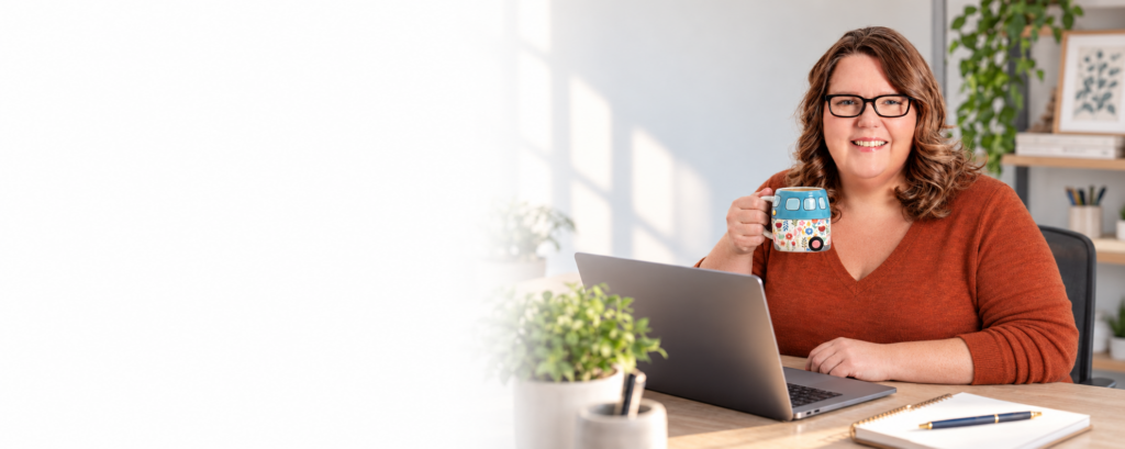 Lisa Duck holding a coffee mug at her laptop, with white space to the left.